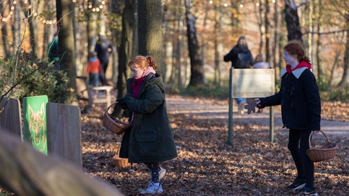 Children playing games on a fairytale trail at Christmas